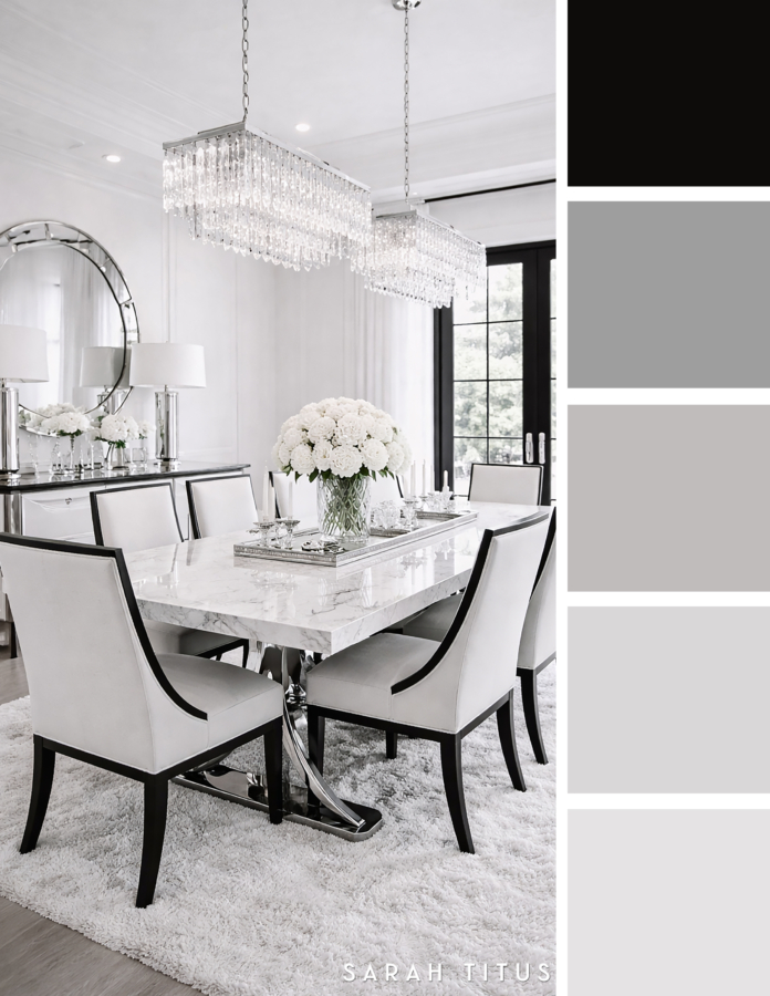 Bright luxury dining room with a marble table, white upholstered chairs, crystal chandeliers, silver decor, and black framed doors in a white, gray, and silver palette.