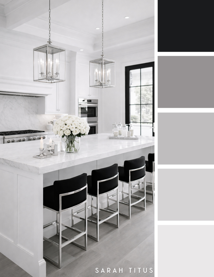 Bright white kitchen with a marble island, black bar stools, silver lantern pendants, white roses, and black framed window trim in a black, white, gray, and silver palette.